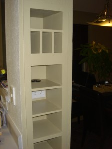 Other side of kitchen entry with cubbies built in columns...notice the electrical outlet to charge our phones